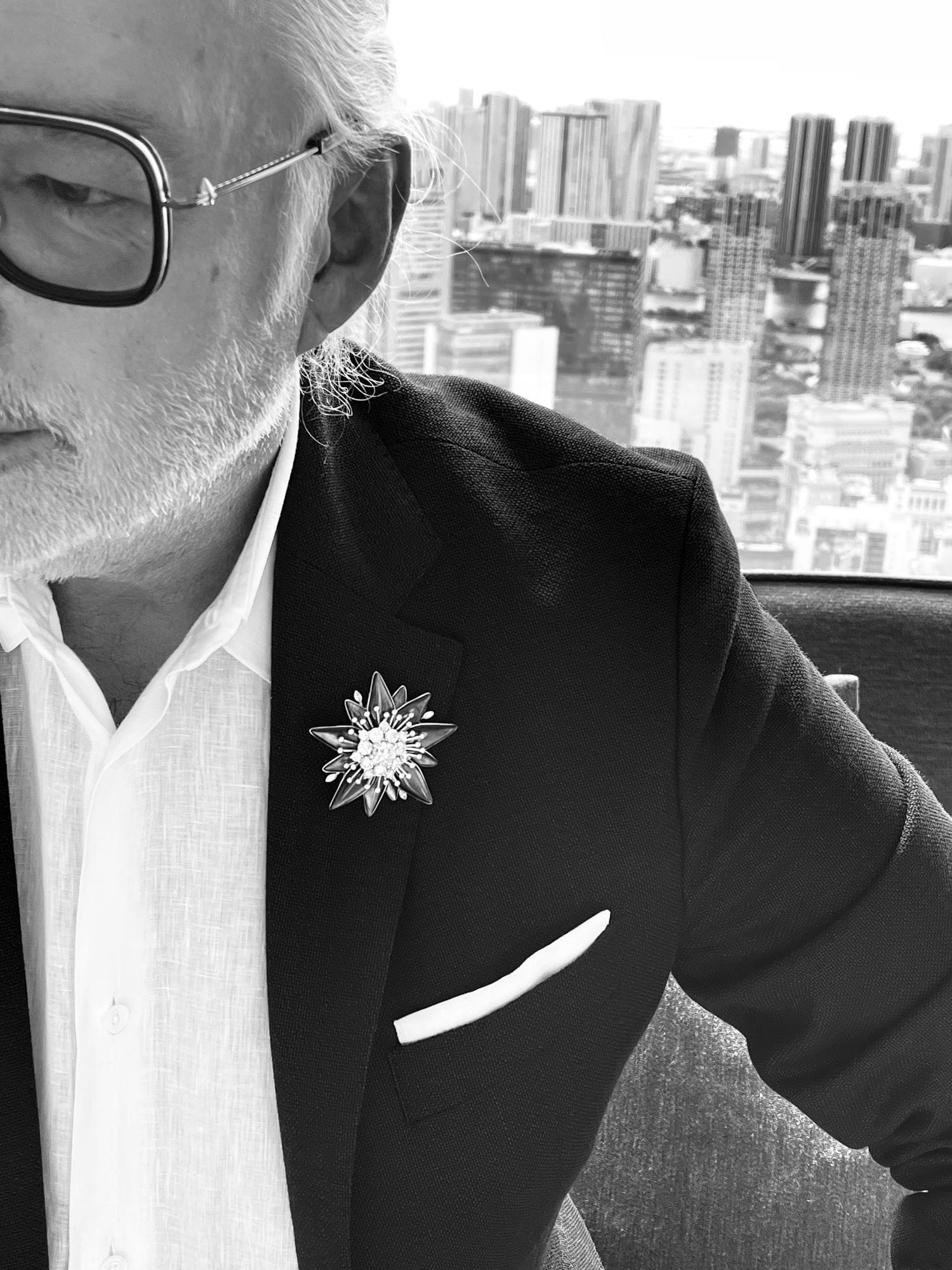 Black and white editorial detail of Noir Alpine bespoke brooch worn at the Andaz Tokyo